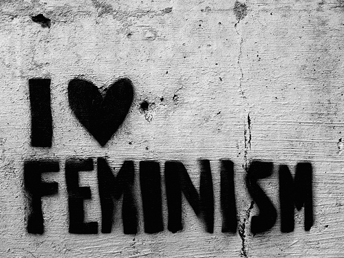 Graffiti stencil on a wall with cracked and peeling rendered surface