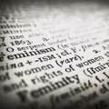 A close-up image of a dictionary, focussed on the word *Feminism* (the word *Femininity* is just out of focus below it)