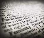 A close-up image of a dictionary, focussed on the word *Feminism* (the word *Femininity* is just out of focus below it)