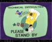 A screenshot from the Simpsons showing Kent Brockman caricatured as a cuckoo clock by his own TV station with words TECHNICAL DIFFICULTIES PLEASE STAND BY