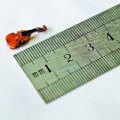 Tiny violin/fiddle less than half an inch long "Chen, of Beijing, China, took seven years to craft the tiny instrument from 30 separate parts with strings thinner than a human hair."