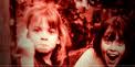 Bitch, PhD header image. Two little girls, possibly from the seventies, are looking into the camera. One laughing, one flipping the bird.