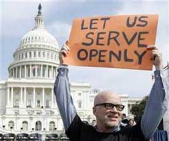 A man holding a sign outside the US Capitol building, sign reads *Let Us Serve Openly*