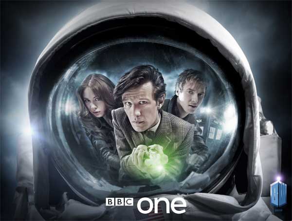 A astronaut's face mask reflects Amy, The Doctor and Rory looking anxious - The Doctor is holding his sonic screwdriver out, activated