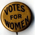 a badge or button displaying the words VOTES FOR WOMEN