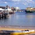 A ferry approaches Manly Wharf, as seen from the harbour beach