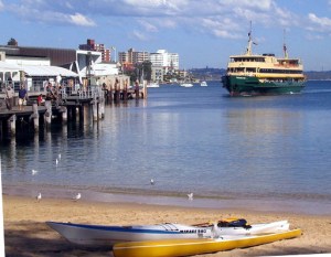 A ferry approaches Manly Wharf, as seen from the harbour beach