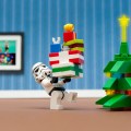 Lego Stormtrooper carries Lego presents to a Lego Christmas tree