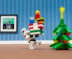 Lego Stormtrooper carries Lego presents to a Lego Christmas tree
