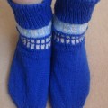 TARDIS socks. They are dark blue with white windows and light blue panelling with white writing on it that says Police Box.