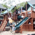 Kids on a playground surrounded by houses