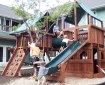 Kids on a playground surrounded by houses