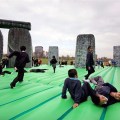 An inflatable bouncy sculpture of Stonehenge full of happy kids