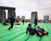 An inflatable bouncy sculpture of Stonehenge full of happy kids