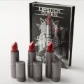 Three lipsticks arranged in front of a book-like presentation box.