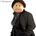 A cabbagepatch doll customised to look like Sherlock Holmes as played by Benedict Cumberbatch