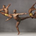 Three men in mid-leap dance poses