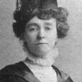 B&W photo of a white, Edwardian woman in academic cap and gown