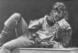B&W photo of Jeremy Irons lying on his side, in cavalier costume.
