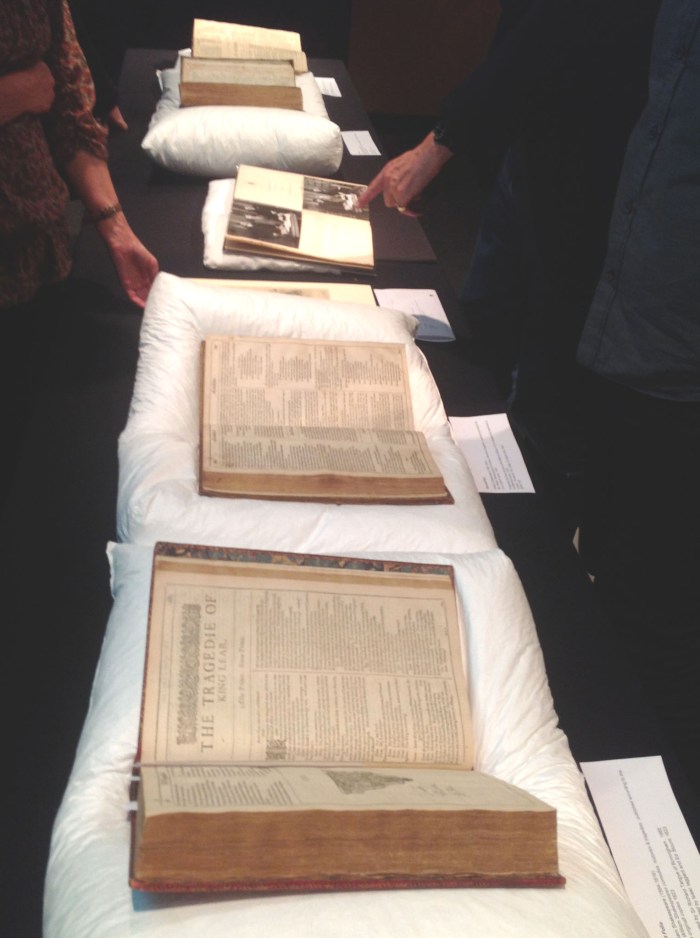 Four of Shakespeare's original folios laid in a line.