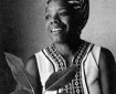 B&W of Maya Angelou as a young woman, in traditional African dress.
