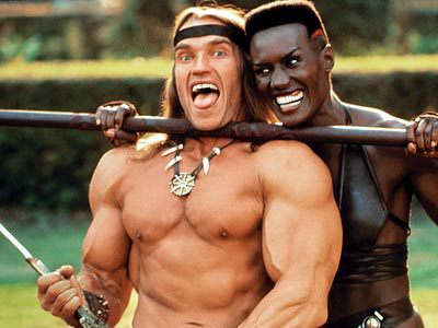 Arnold Schwarzenegger and Grace Jones fooling around with sharp pointy things on the set of Conan The Destroyer