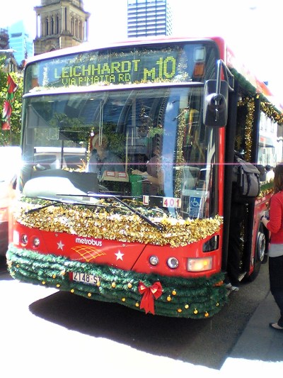 Red bus covered in tinsel and other Christmas decorations