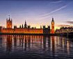 Photograph of Westminster Palace, home of the UK Parliament, taken at dusk from across the river Thames.