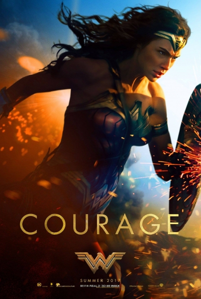 A dark-haired amazon carries a shield before her body resolutly amid a shower of sparks, the image is captioned COURAGE