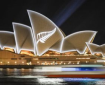 A silver fern projected onto sail structure of Sydney Opera House
